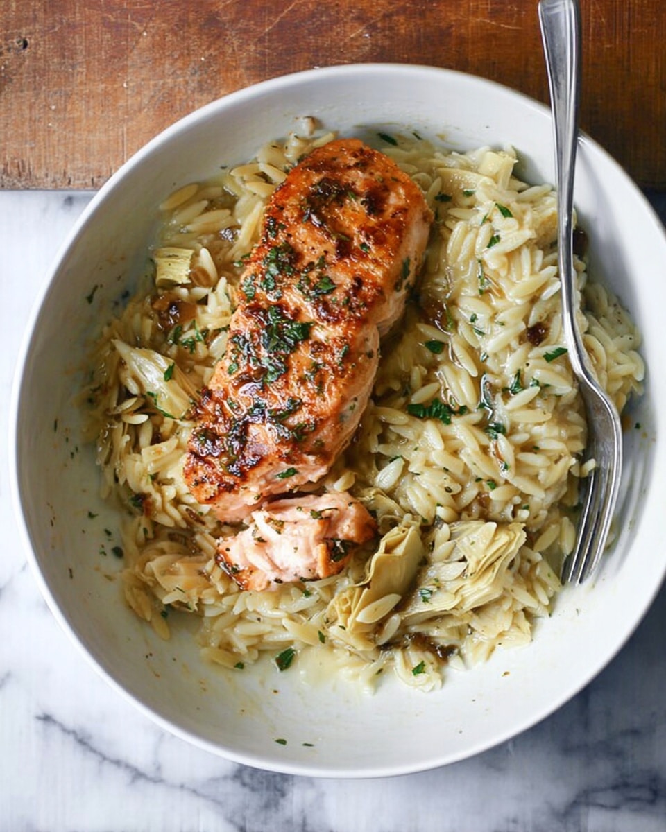 A white pan filled with a creamy light yellow sauce base mixed with herbs and small pasta pieces, topped with four golden-brown cooked fish fillets evenly spaced across the surface. The fish has a slightly crispy texture with some char marks and is sprinkled with small pieces of fresh green herbs. A wooden spoon is scooping some of the pasta and sauce on the left side, showing its thick and smooth texture. The pan rests on a white marbled surface. photo taken with an iphone --ar 4:5 --v 7