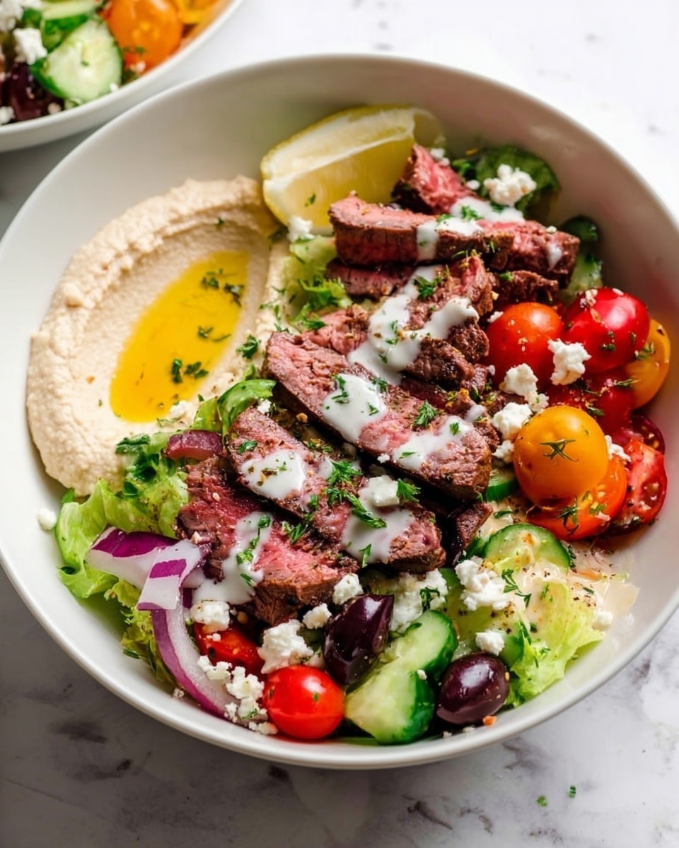 The image shows a white bowl with a colorful salad. At the bottom, there is green lettuce and cucumber pieces. On one side, there is a smooth light beige spread of hummus with a drizzle of olive oil. Above it, bright cherry tomatoes in red and orange add color. Slices of pinkish steak with herbs are laid on top, and there are black olive halves mixed in. White creamy dressing is drizzled over the whole dish, and small white crumb-like cheese bits are scattered throughout. A lemon wedge rests near the edge of the bowl. The bowl sits on a white marbled surface. photo taken with an iphone --ar 4:5 --v 7