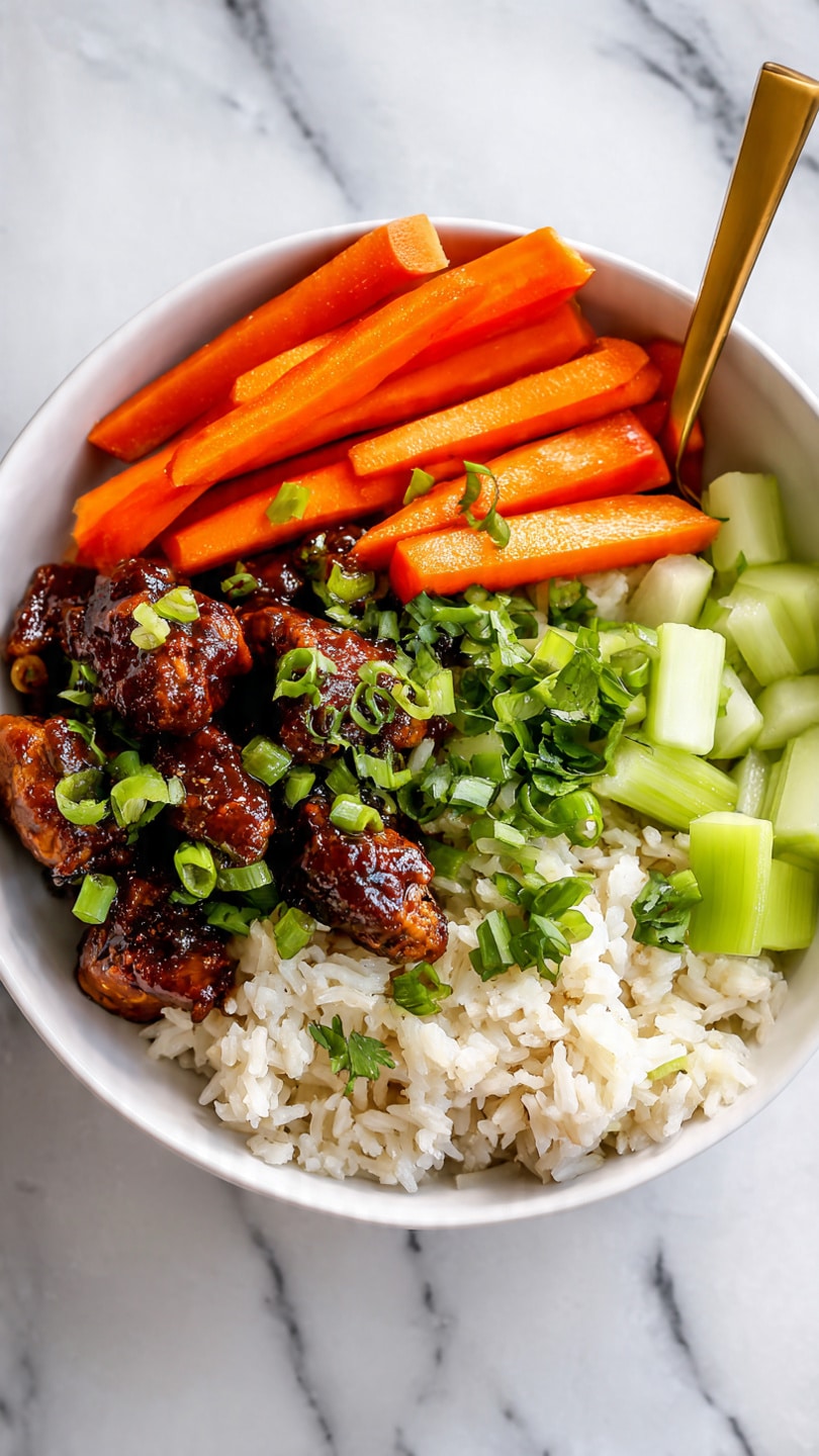 The image shows a white bowl filled with a colorful dish. At the bottom, there is white and brown rice with a soft texture. On top of the rice, there are small pieces of dark brown, sauce-coated chicken scattered all over. On one side, long, fresh orange carrot sticks stand upright. Next to the carrots, there are light green celery chunks. The dish is garnished with bright green chopped scallions spread across the chicken and vegetables. A gold fork stands inside the bowl on the right side. The bowl rests on a white marbled surface. Photo taken with an iphone --ar 4:5 --v 7