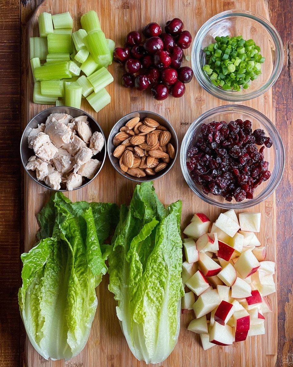The image shows a wooden board with various fresh ingredients neatly arranged. Starting from the top left, there are light green celery pieces, followed by dark red halved cherries. To the right, a small clear glass bowl holds chopped green onions. Below the celery, a small metal cup contains sliced almonds. In the middle, a clear glass bowl is filled with dark red dried cranberries. To the right of the bowl are light red and white chopped apple pieces. At the bottom left, there are three large green romaine lettuce leaves. Finally, to the bottom right, there is a pile of light beige cooked chicken pieces. The background is a warm wooden surface. photo taken with an iphone --ar 4:5 --v 7