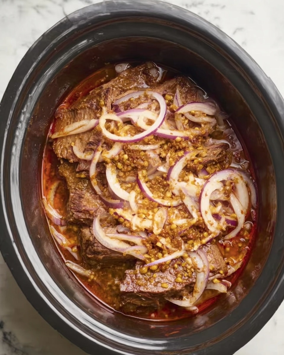 The image shows a slow cooker filled with cooked meat topped with thinly sliced onions and small bits of a yellowish ingredient, all sitting in a reddish-brown sauce. The meat is layered at the bottom, covered evenly by the onions and the small yellow pieces, which add texture and color contrast. The inside of the cooker is dark, highlighting the rich colors of the food. The liquid sauce surrounds the layers, creating a moist look. The whole scene is set against a white marbled surface. photo taken with an iphone --ar 4:5 --v 7