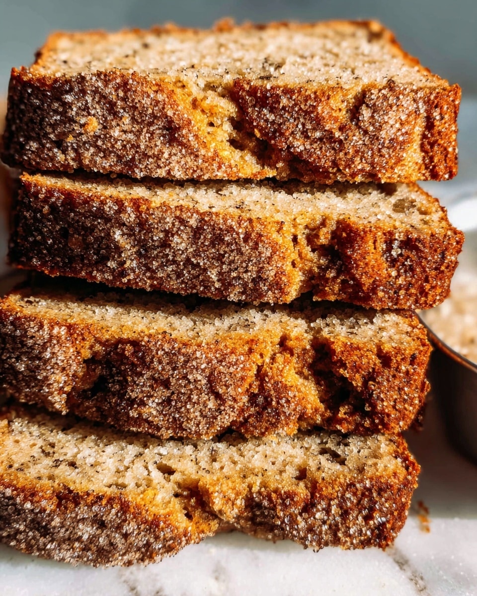 The image shows a close-up of five thick slices of a golden-brown cake with a rough, crumbly texture covered in a light layer of sugar crystals on top. The cake has a dense, moist interior with tiny dark specks evenly spread throughout. The slices are stacked slightly overlapping on a white marbled surface, revealing the textured inner part and the crusty top layer that appears crunchy and coarse. The lighting highlights the grainy sugar and the uneven, rustic edges of the cake photo taken with an iphone --ar 4:5 --v 7