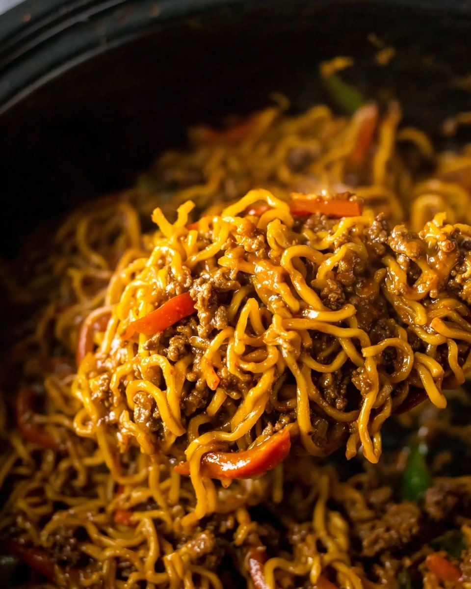 A white bowl filled with cooked noodles mixed with small brown meat pieces, thin orange carrot strips, and red bell pepper slices. The noodles have a glossy, saucy look with a rich brown color, and the dish is topped with small bright green chopped scallions and white sesame seeds sprinkled on top. The bowl is placed on a white marbled surface with a turquoise patterned cloth partly visible beneath. Photo taken with an iphone --ar 4:5 --v 7