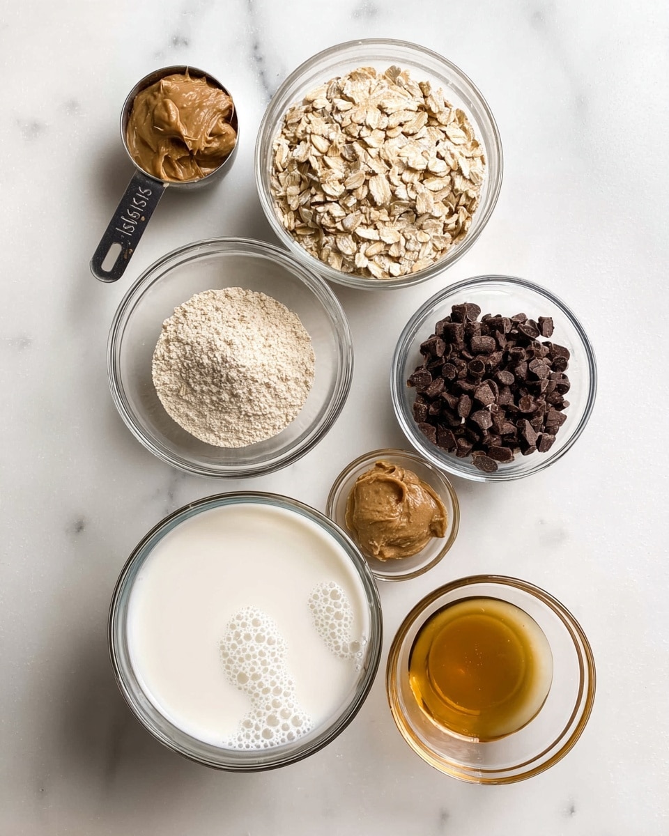 The image shows six small bowls and a measuring cup arranged on a white marbled surface. The measuring cup at the top left contains light-colored rolled oats. To its right, a clear glass bowl holds dark brown chocolate chips. Below the oats, a clear glass bowl has a light beige powder, likely flour. Next to it in the center is a clear bowl with dark brown sugar. Below that, a white bowl filled with white milk shows bubbles on the surface. To the left of the milk, another small clear bowl contains a small amount of peanut butter with a smooth texture. At the top right, a clear bowl holds a small amount of golden-colored liquid, probably vanilla extract. The overall arrangement is neat and well-spaced. Photo taken with an iphone --ar 4:5 --v 7