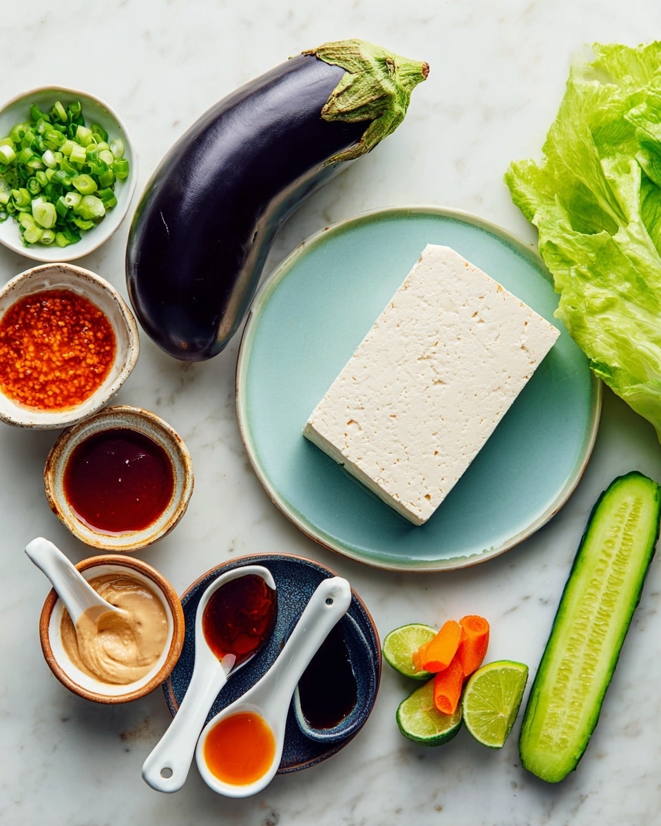 A light blue plate holds one whole dark purple eggplant with its green top, positioned next to a thick block of white tofu. Around the plate on a white marble surface, there are several small bowls: one with chopped green onions, one with a light tan sauce, one with a reddish-brown sauce, and another with a golden-brown sauce. There are also three white spoons resting on a small dark blue plate, each filled with different sauces—red, dark brown, and orange. To the right are fresh green lime wedges, a long slice of cucumber, and a piece of carrot, while at the bottom right corner, fresh green lettuce leaves are visible. The overall setup looks clean and fresh. photo taken with an iphone --ar 4:5 --v 7