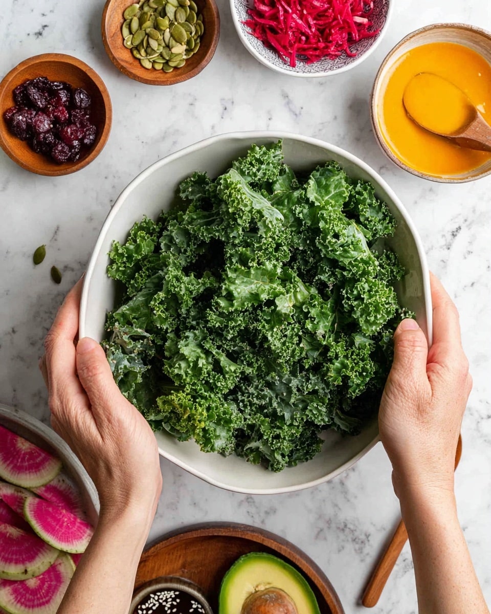 A large white bowl is filled with curly, deep green kale leaves, being held and mixed by two woman’s hands. Around the bowl on a white marbled surface, there are small round bowls with bright orange dressing with a wooden spoon, dark red dried cranberries, green pumpkin seeds in a wooden bowl, shredded deep red beets in a scalloped bowl, and a small bowl with a dark liquid dressing with white sesame seeds floating on top. There is also a halved watermelon radish showing its pink inside and part of a halved avocado with its brown seed showing. Photo taken with an iphone --ar 4:5 --v 7