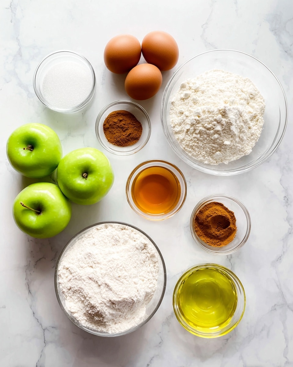 The image shows a white marbled surface with baking ingredients neatly arranged. There are four green apples in a cluster on the left, with a small glass bowl of white granulated sugar, and another small glass bowl with brown spice, likely cinnamon next to it. Closer to the middle, there is a clear glass bowl filled with white flour. Above the flour are two brown eggs side by side, a small glass jar of orange-colored liquid, and a small bowl with amber liquid, possibly vanilla or syrup. On the right side, there is a white bowl filled with more white granulated sugar and a small glass bowl with yellow oil. Each item is spaced evenly creating a tidy and bright setup. Photo taken with an iphone --ar 4:5 --v 7