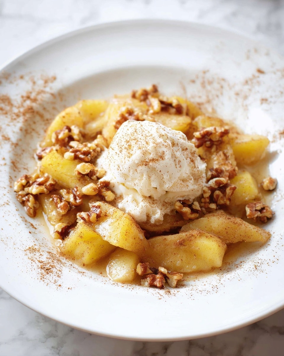 The dish shows a single layer of sliced cooked yellow apples spread out on a white plate. On top of the apples, there are many small pieces of brown walnuts scattered evenly. In the center, there is one scoop of creamy white ice cream with a smooth texture. The whole dish is sprinkled with light brown cinnamon powder and has a light syrup that shines on the apples and nuts. The background is a white marbled texture. photo taken with an iphone --ar 4:5 --v 7